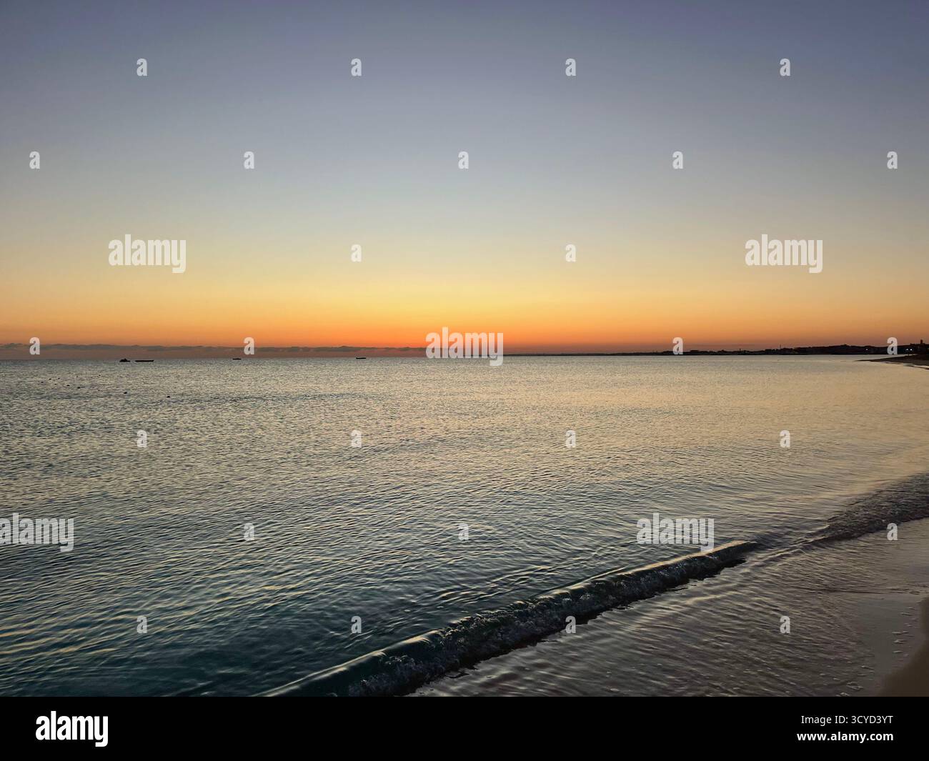 Sunset over calm Mediterranean waters with soft waves and pastel sky, evoking peace and serenity at the Egyptian coastline. - Smartphone Captured Stock Image