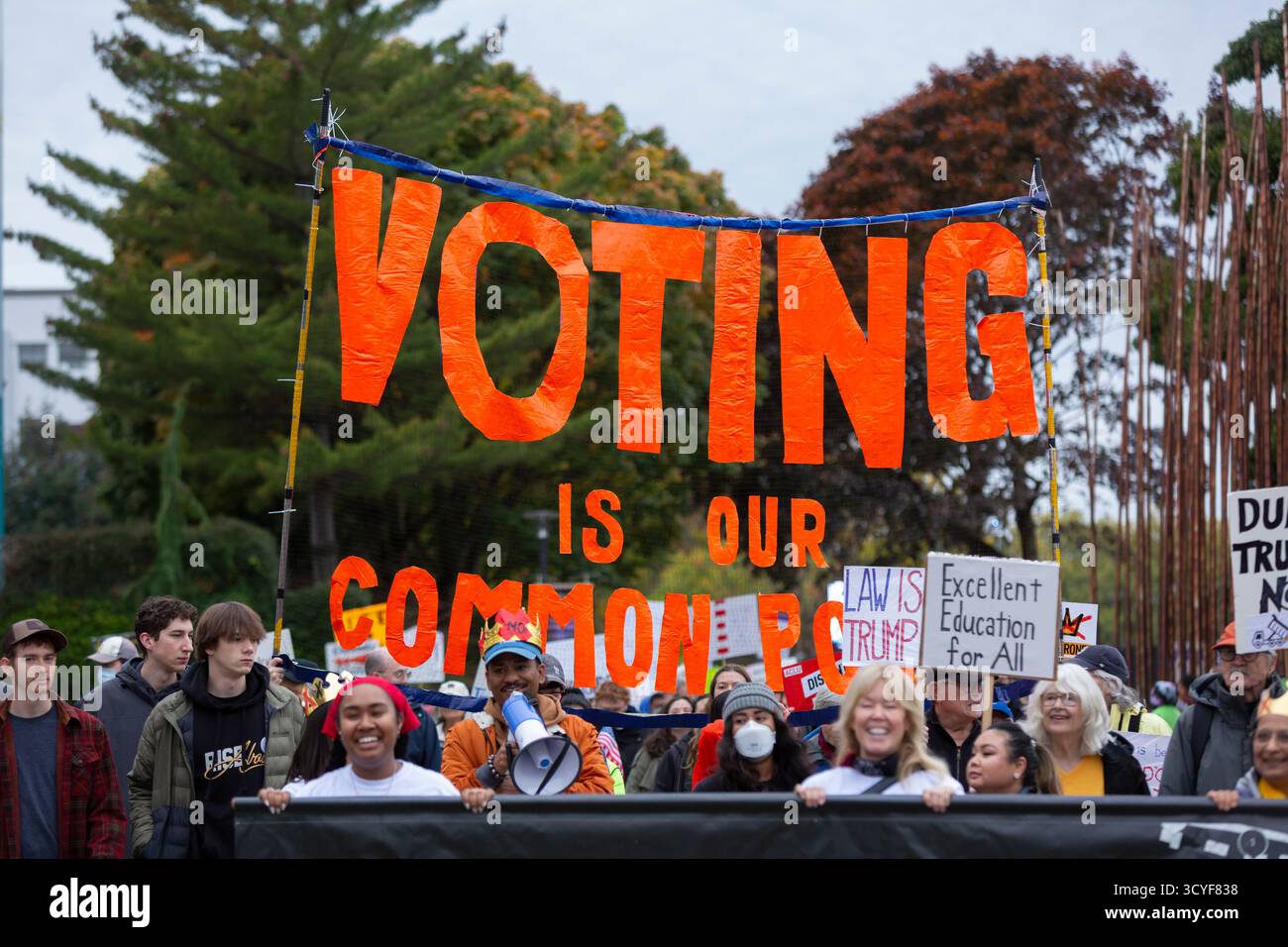 Seattle, Washington, USA. 18th October 2025. Protesters lead the way at the “No Kings” protest and march. An estimated 90,000 people attended the mass protest as part of a national day of peaceful action organized by the No Kings coalition in response to perceived authoritarian actions and corruption of the Trump administration. Credit: Paul Christian Gordon/Alamy Live News Stock Photo