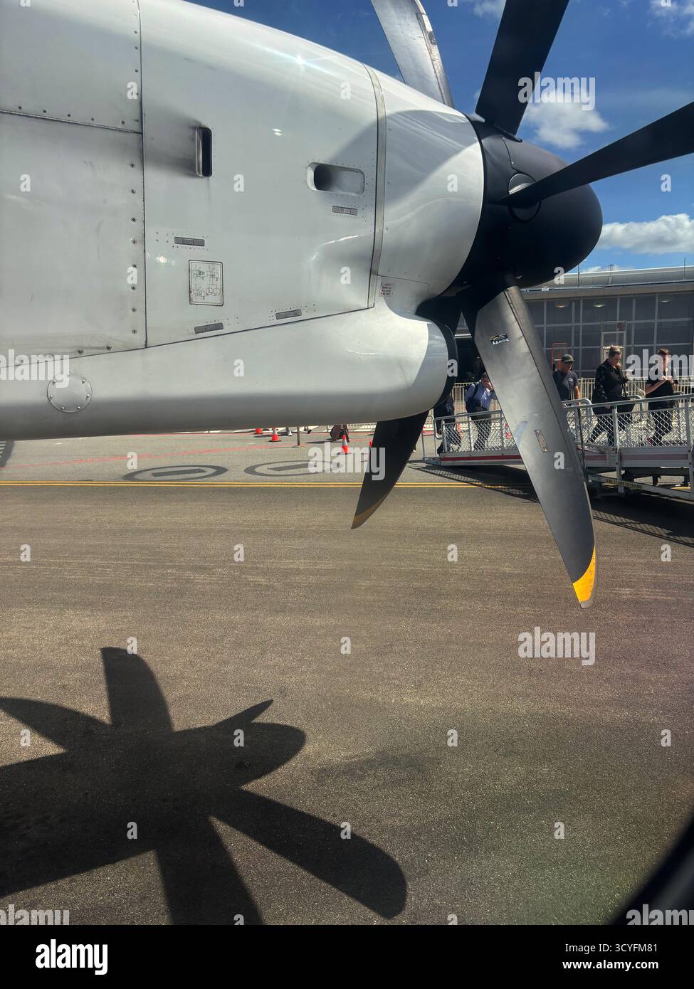 People boarding by ramp onto Dash-8 propeller aircraft, Port Lincoln airport, South Australia. No MR or PR - Smartphone Captured Stock Image
