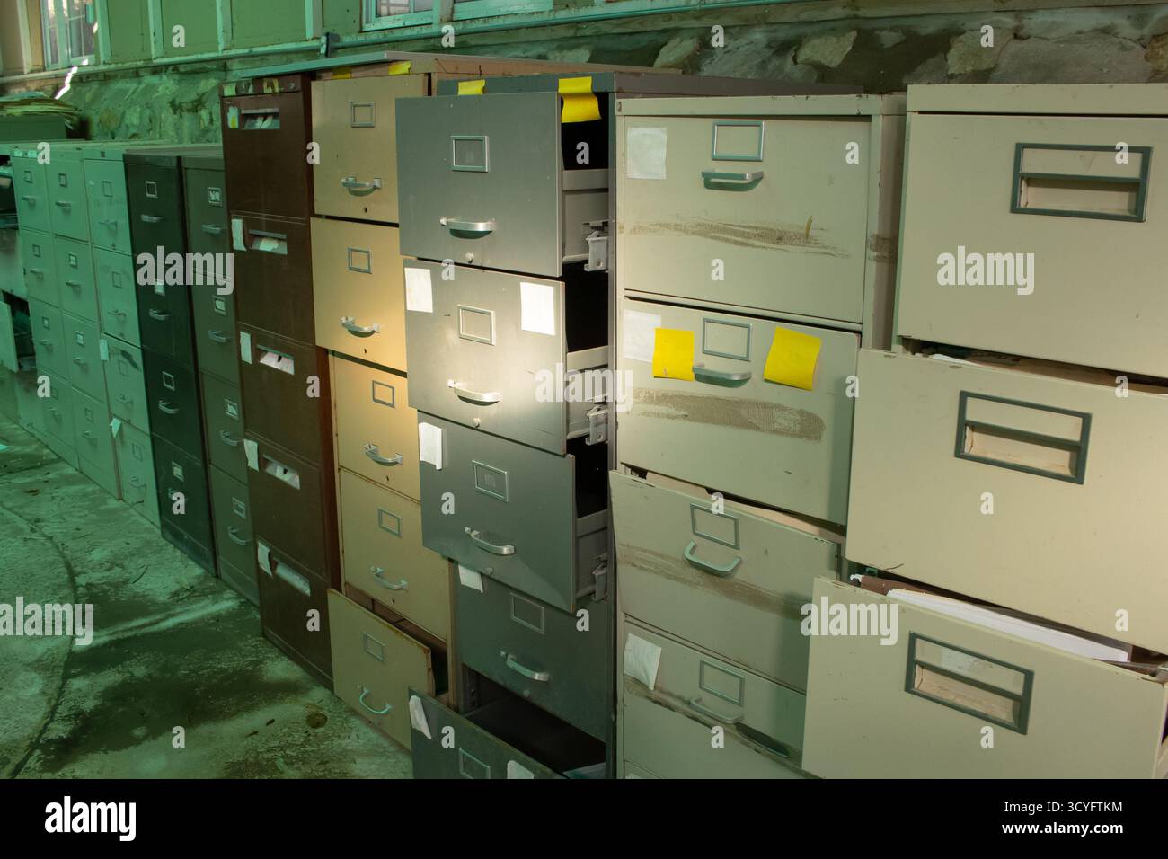 A view of a room full of abandoned filing cabinets Stock Photo - Alamy