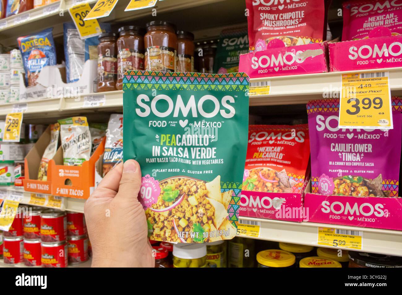 Los Angeles, California, United States - 02-01-2023: A view of a hand holding a package of Somos taco filling, on display at a local grocery store. Stock Photo