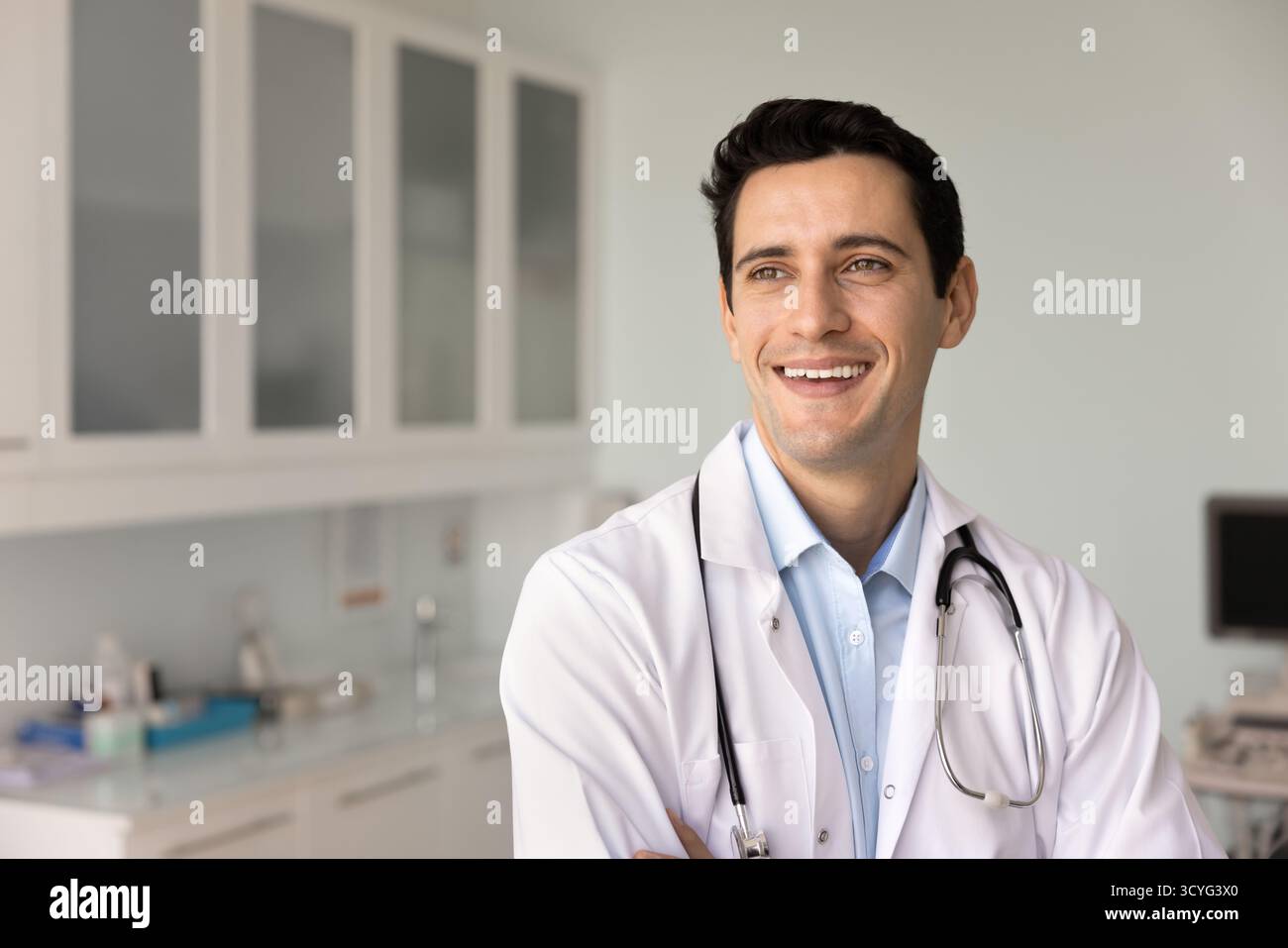 Doctor looks into distance with optimistic expression Stock Photo