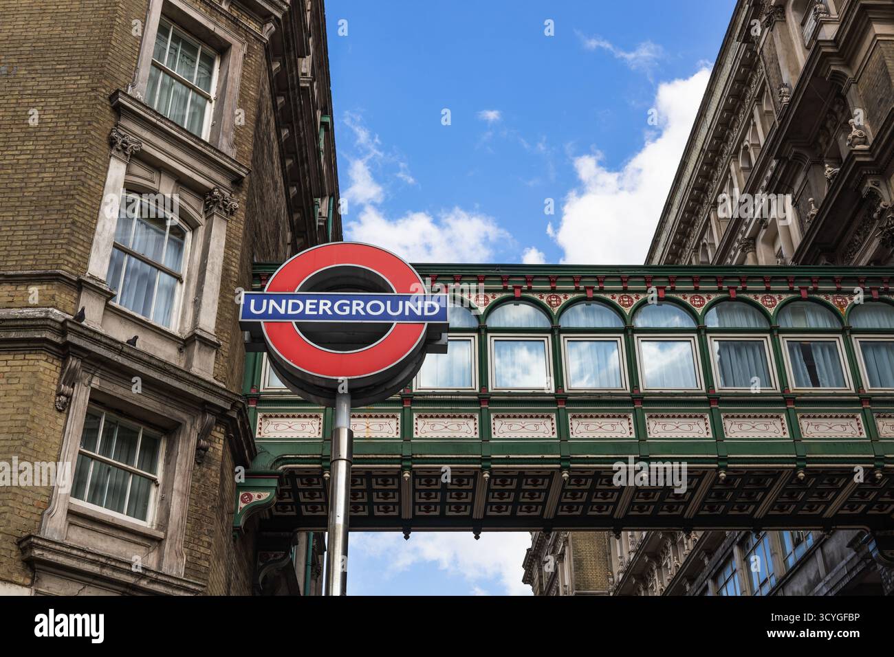 Underground Rundel London Underground roundel under glass skybridge between historic ...