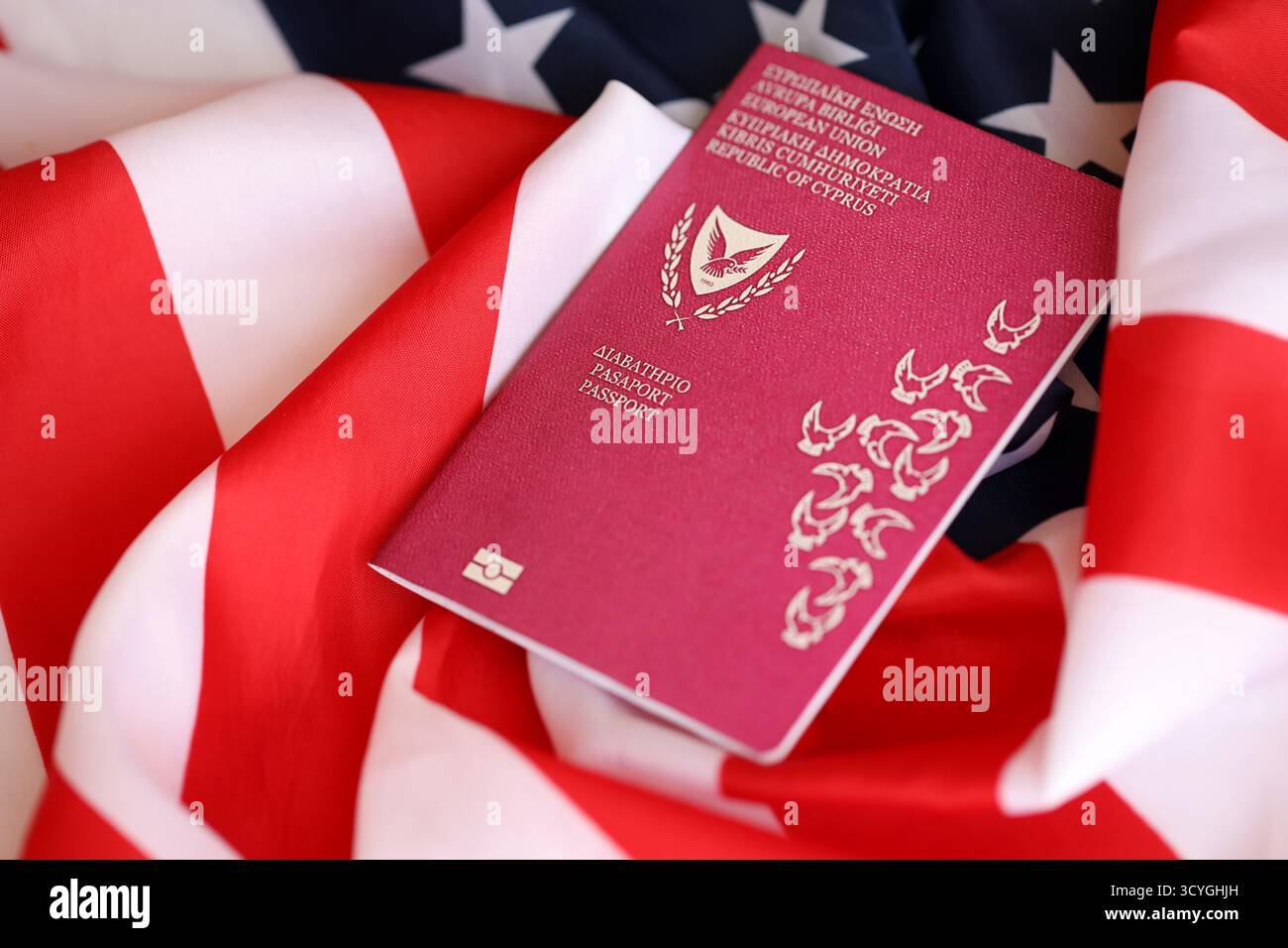 Kyprus passport on big waving flag of United States of America close up. US Visa and immigration concept Stock Photo