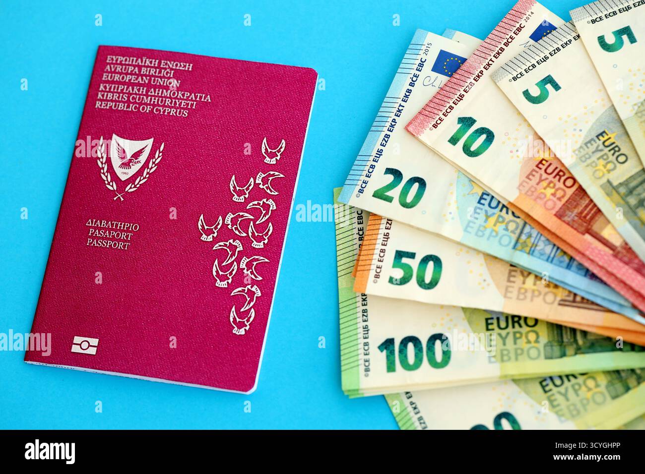 Kyprus passport lies with euro money banknotes on blue background close up. Salary and pension in Europe concept Stock Photo