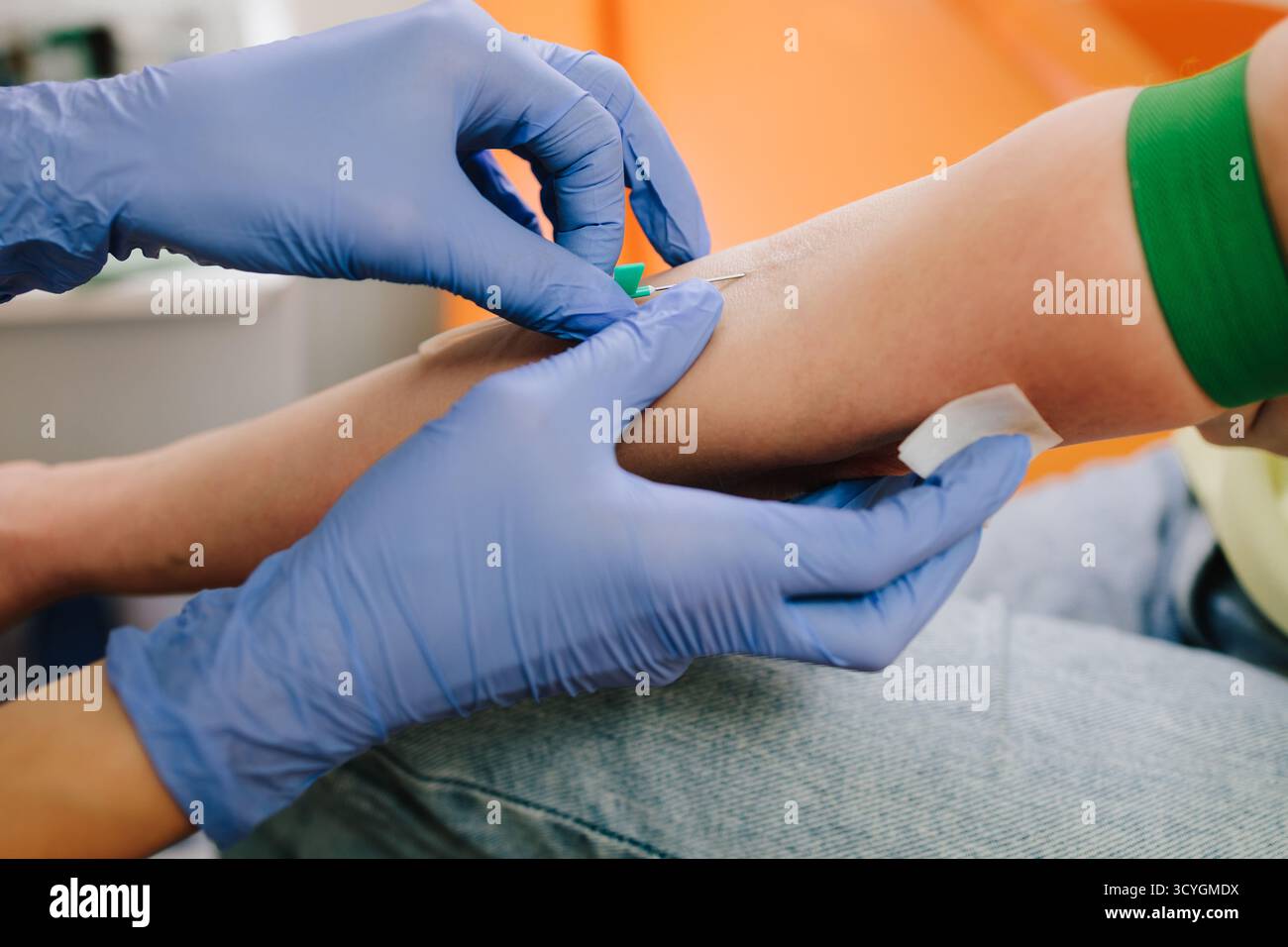 Insert a needle for blood collection close-up. Nurse in sterile gloves ...