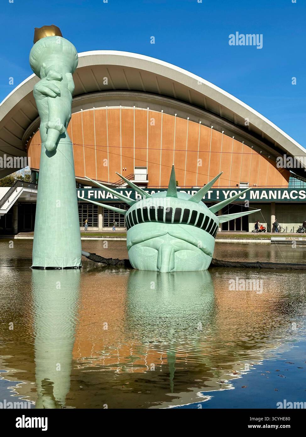 An inflatable Statue of Liberty floats in a pool outside the Haus der Kulturen der Welt, installation with the title status of liberty - Smartphone Captured Stock Image