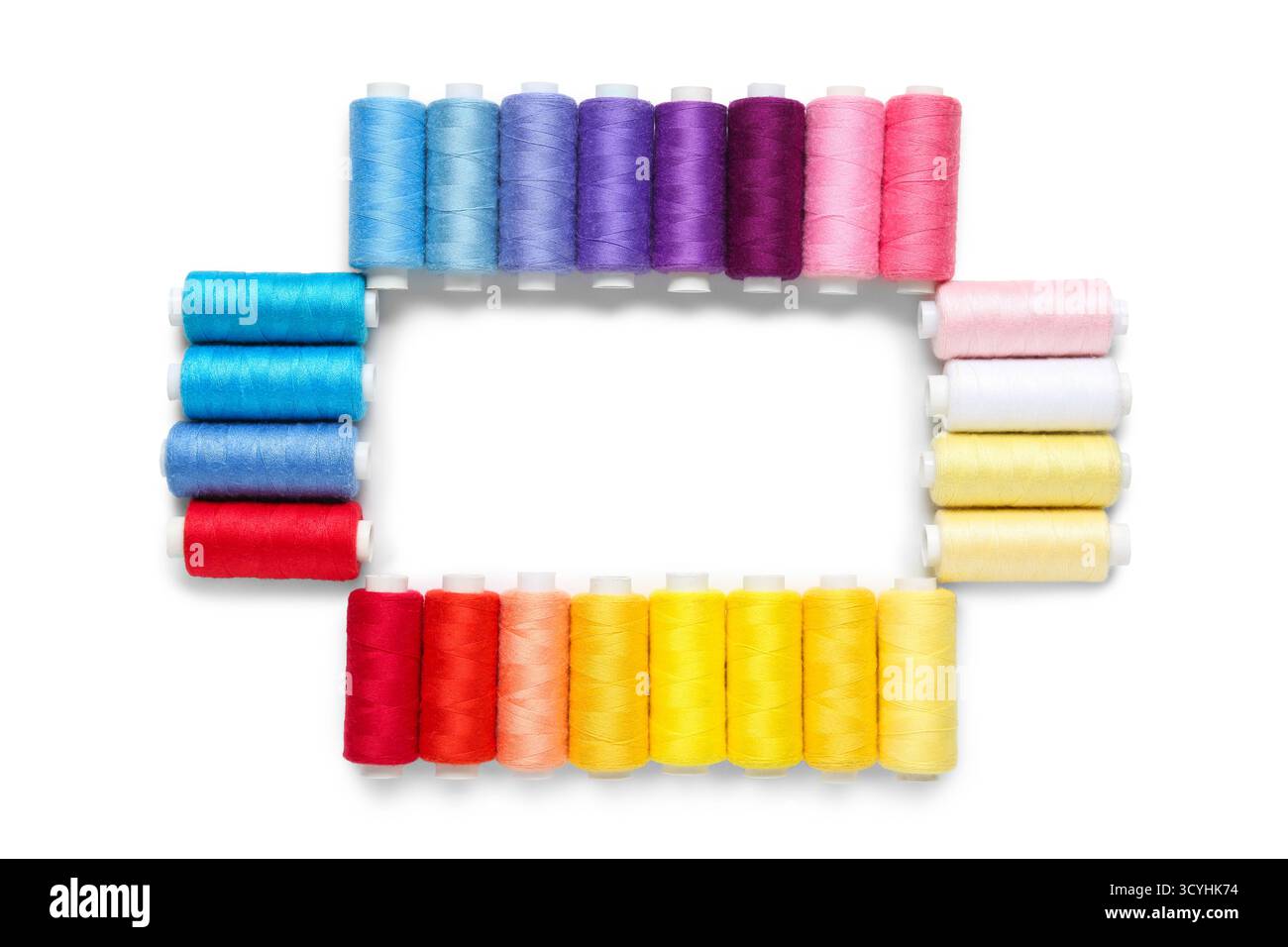 Frame made of colorful thread spools on white background Stock Photo ...