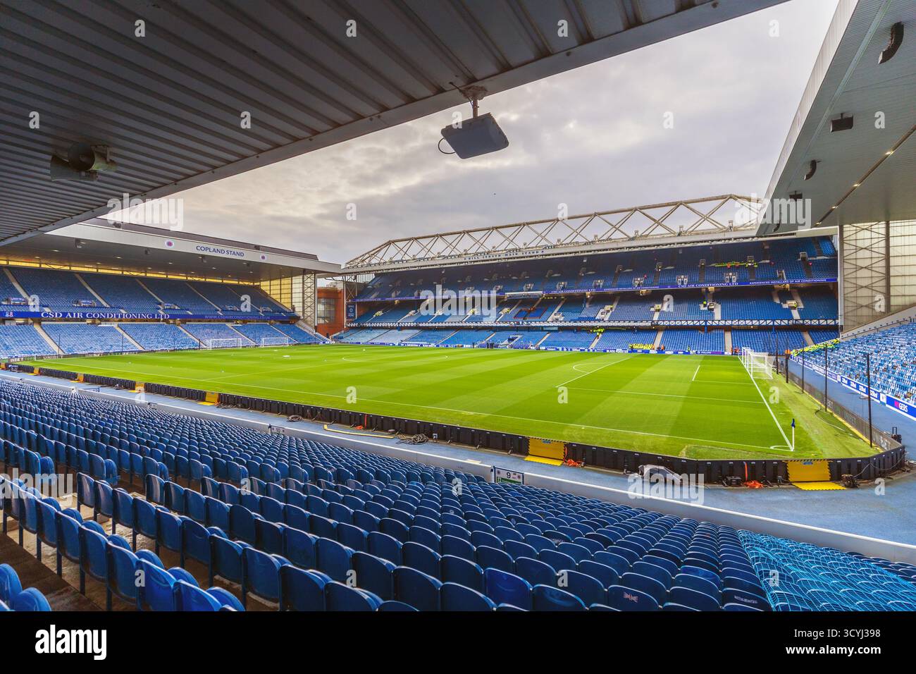 Playing pitch and terracing seats at Ibrox stadium, the home of Rangers FC, Glasgow, Scotland, UK Stock Photo