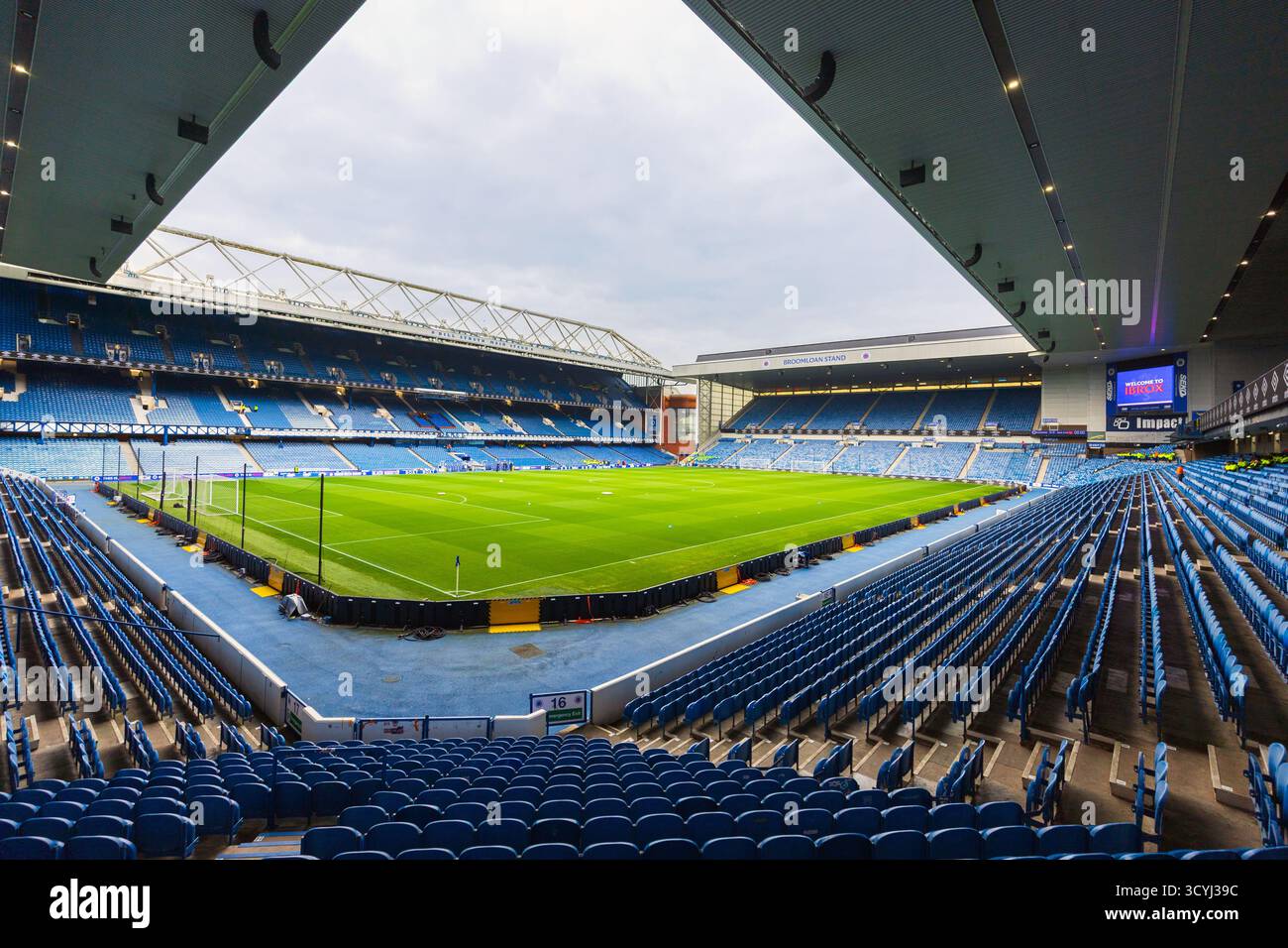 Playing pitch and terracing seats at Ibrox stadium, the home of Rangers FC, Glasgow, Scotland, UK Stock Photo