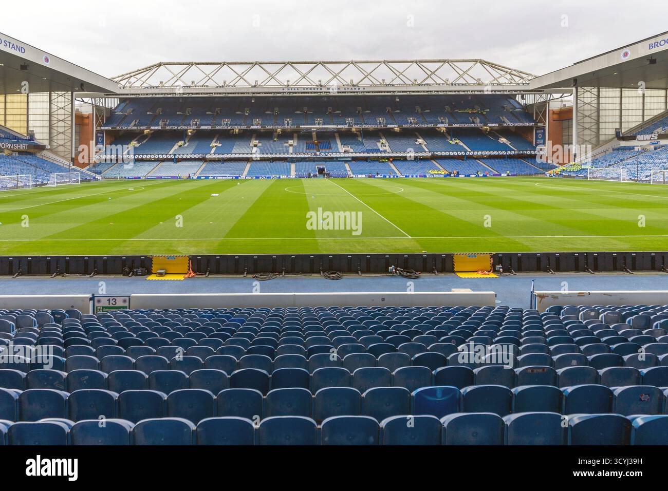 Playing pitch and terracing seats at Ibrox stadium, the home of Rangers FC, Glasgow, Scotland, UK Stock Photo