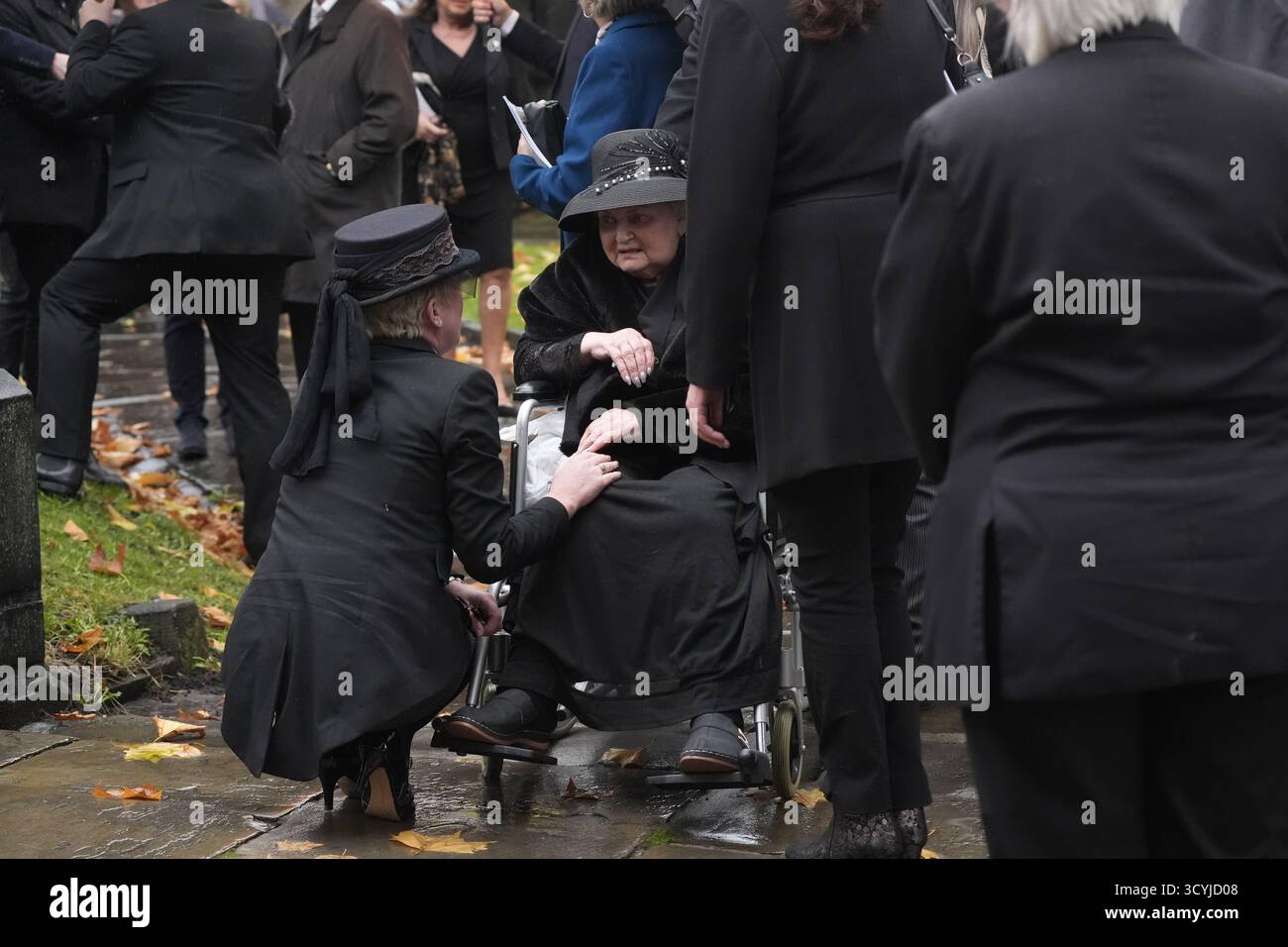 A mourner outside St Mary's Church, Barnsley, following the funeral