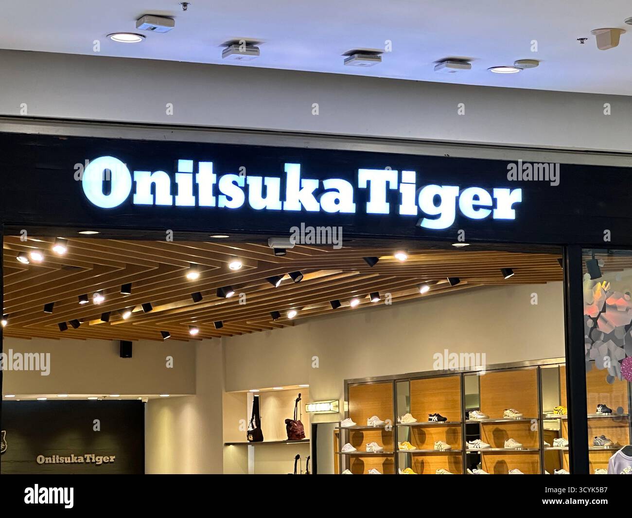 Bangkok, Thailand - Jan 3, 2024: Onitsuka Tiger storefront. Onitsuka Tiger is a Japanese footwear brand. - Smartphone Captured Stock Image