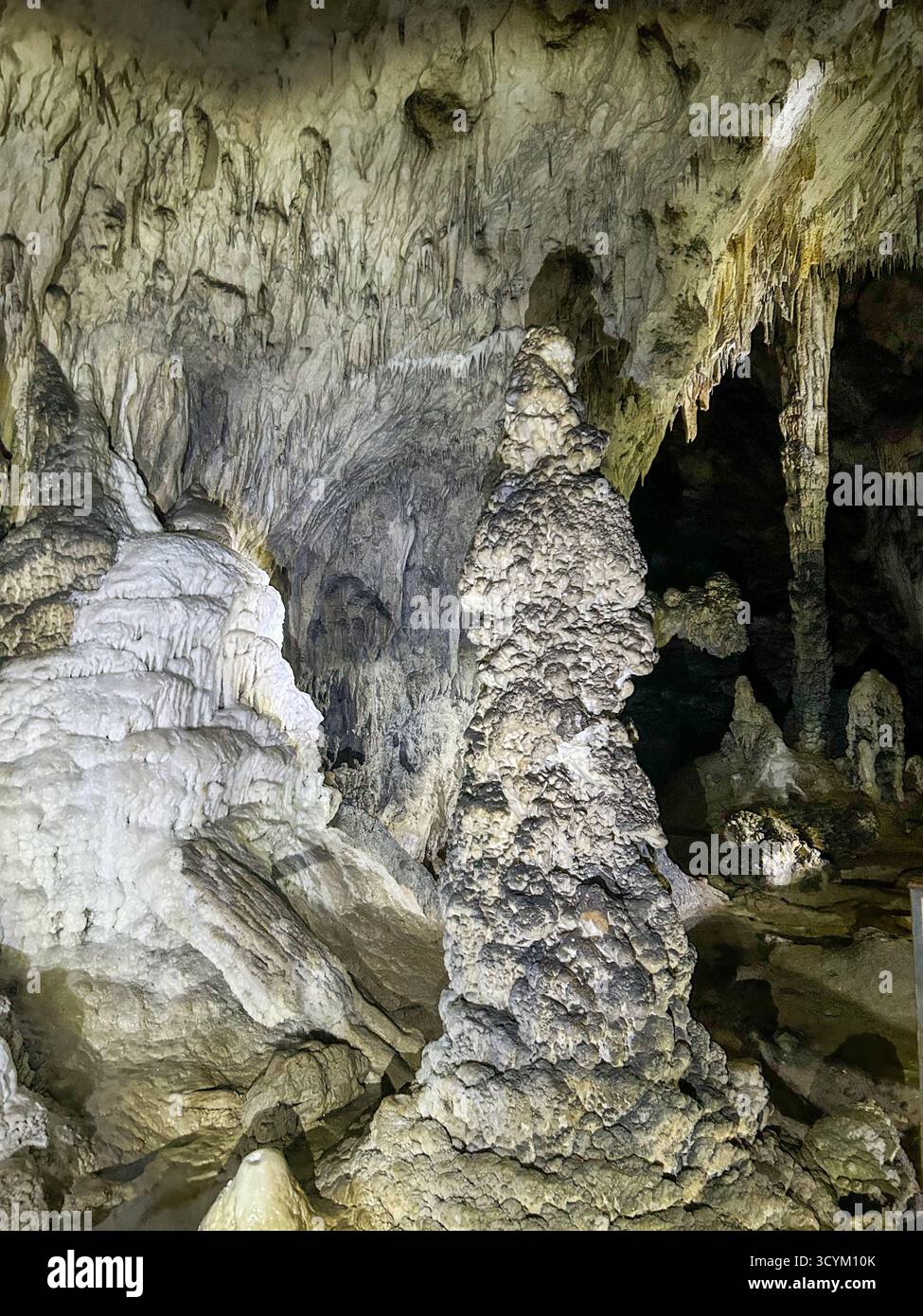 Impressive stalagmites and textured rock formations inside the Ice Cave in Uvac Canyon, showcasing the beauty of Serbia’s underground karst landscape - Smartphone Captured Stock Image