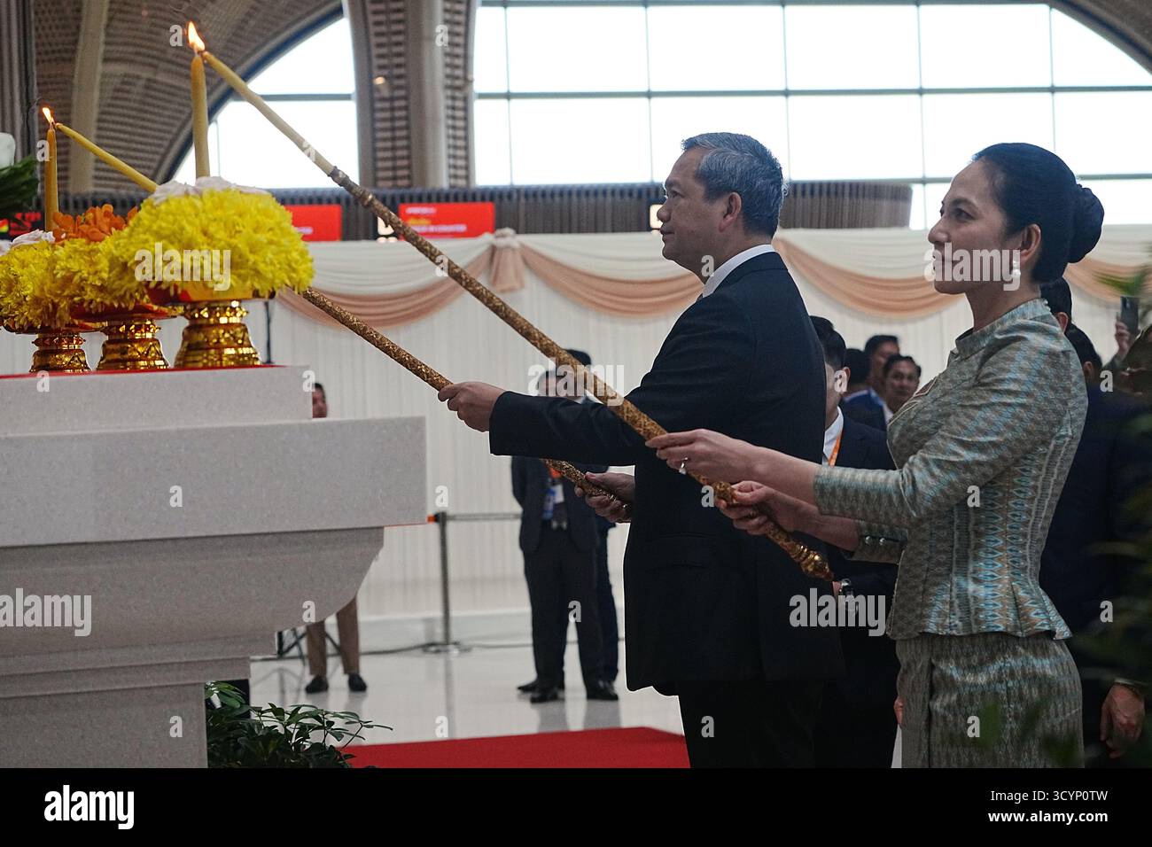Cambodian Prime Minister Hun Manet, left, lights candles together with ...