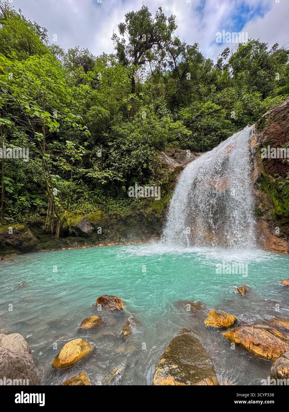 Vibrant Blue Falls and Cascade with Orange-Tinged Rocks, Costa Rica - Smartphone Captured Stock Image