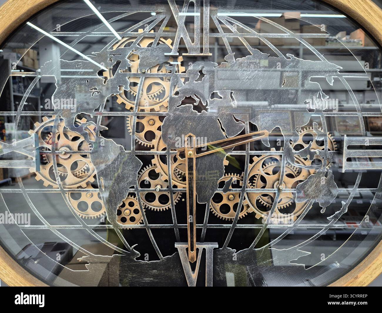 The watch design combines a world map with a complex gear mechanism. - Smartphone Captured Stock Image