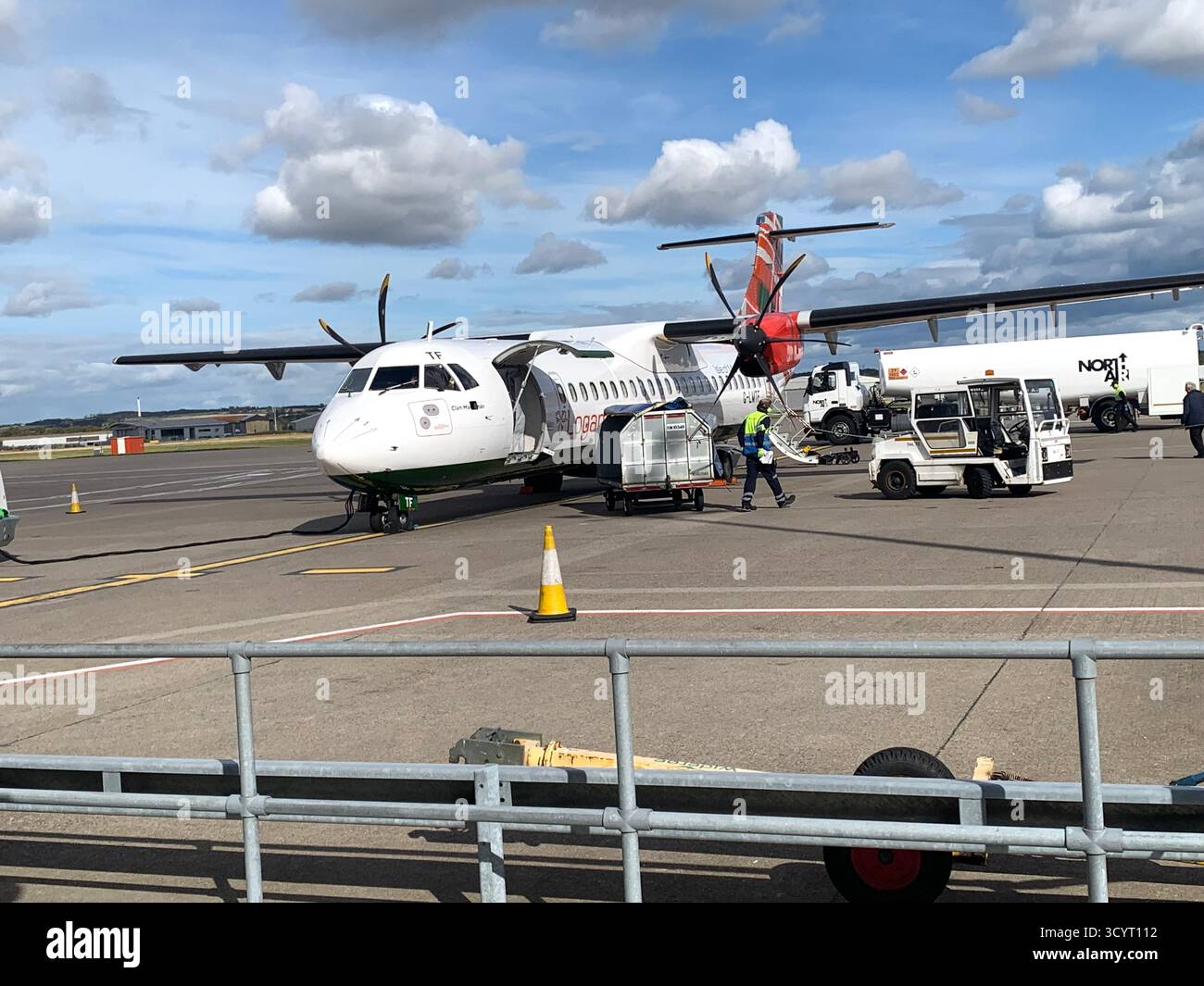Airport Shetland islands KLM Logan Air British Airways plane planes prop aircraft passengers passenger trip visit   runway clouds view weather truck - Smartphone Captured Stock Image