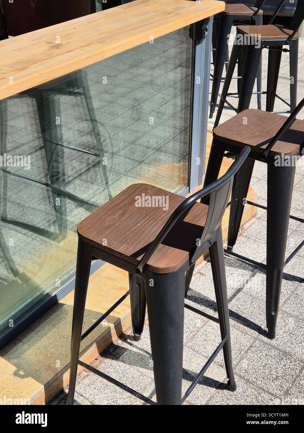 street cafe or seating area with high chairs and a table - Smartphone Captured Stock Image