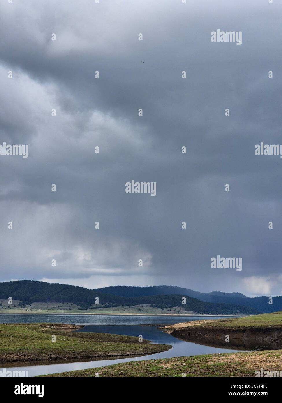 Landscape storm clouds over lake. thunderclouds over mountains and lake - Smartphone Captured Stock Image
