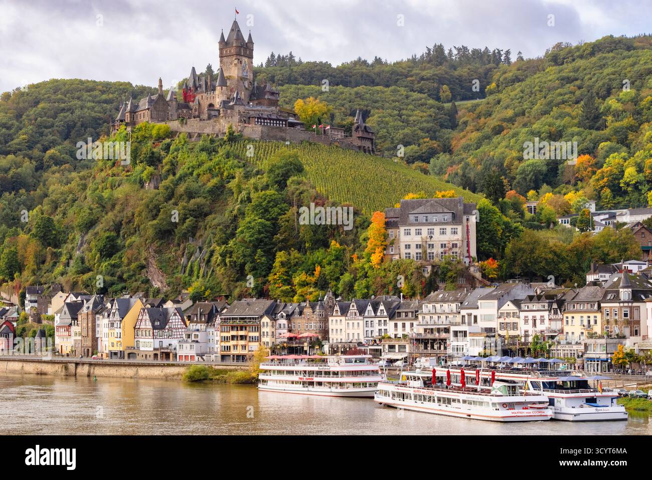 Reichsburg Cochem castle on the hill above the town with boats on the Moselle River. Cochem, Rhineland-Palatinate, Germany, Europe Stock Photo