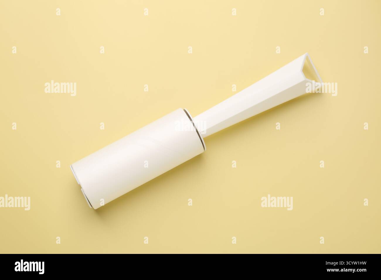 One lint roller on yellow background, top view Stock Photo