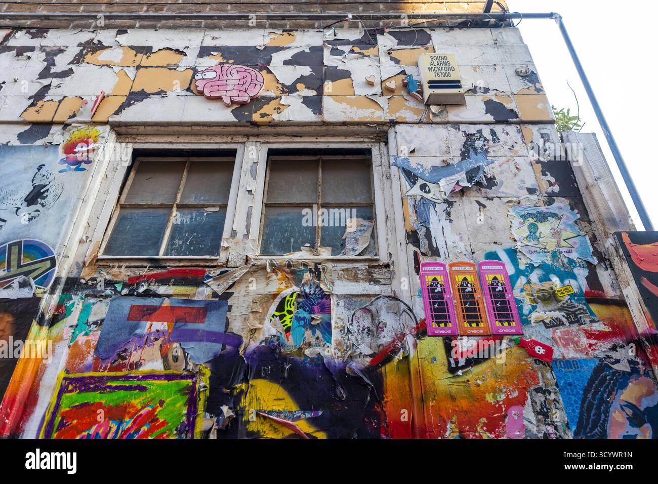 London, UK, May 2, 2025. Low angle view of a distressed building wall ...