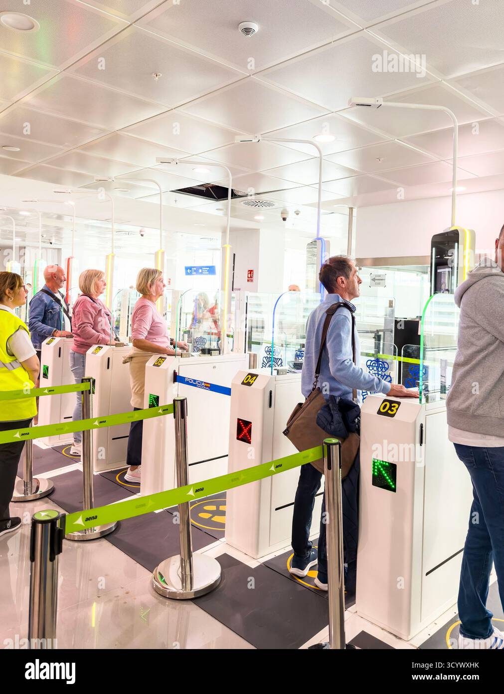 Passengers at newcastle international airport security checkpoint queueing at automated turnstiles for identity verification passport scanning EES - Smartphone Captured Stock Image Passengers at newcastle international airport security checkpoint queueing at automated turnstiles for identity verification passport scanning EES - Smartphone Captured Stock Image