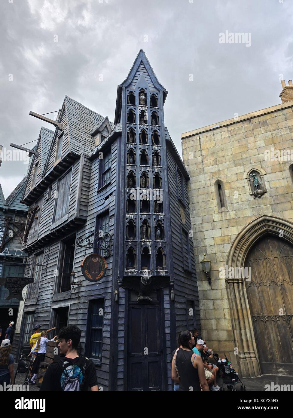 Magical and gothic architecture of Diagon Alley within The Wizarding World of Harry Potter, creating an immersive fantasy experience for theme park - Smartphone Captured Stock Image
