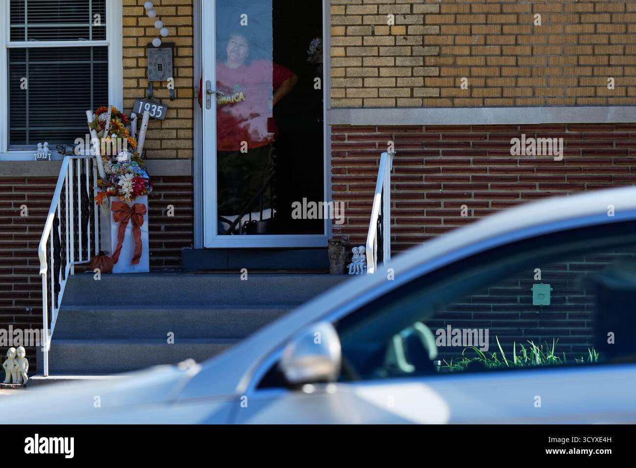 A resident of Broadview, Ill., looks outside as Cook County Sheriff's ...