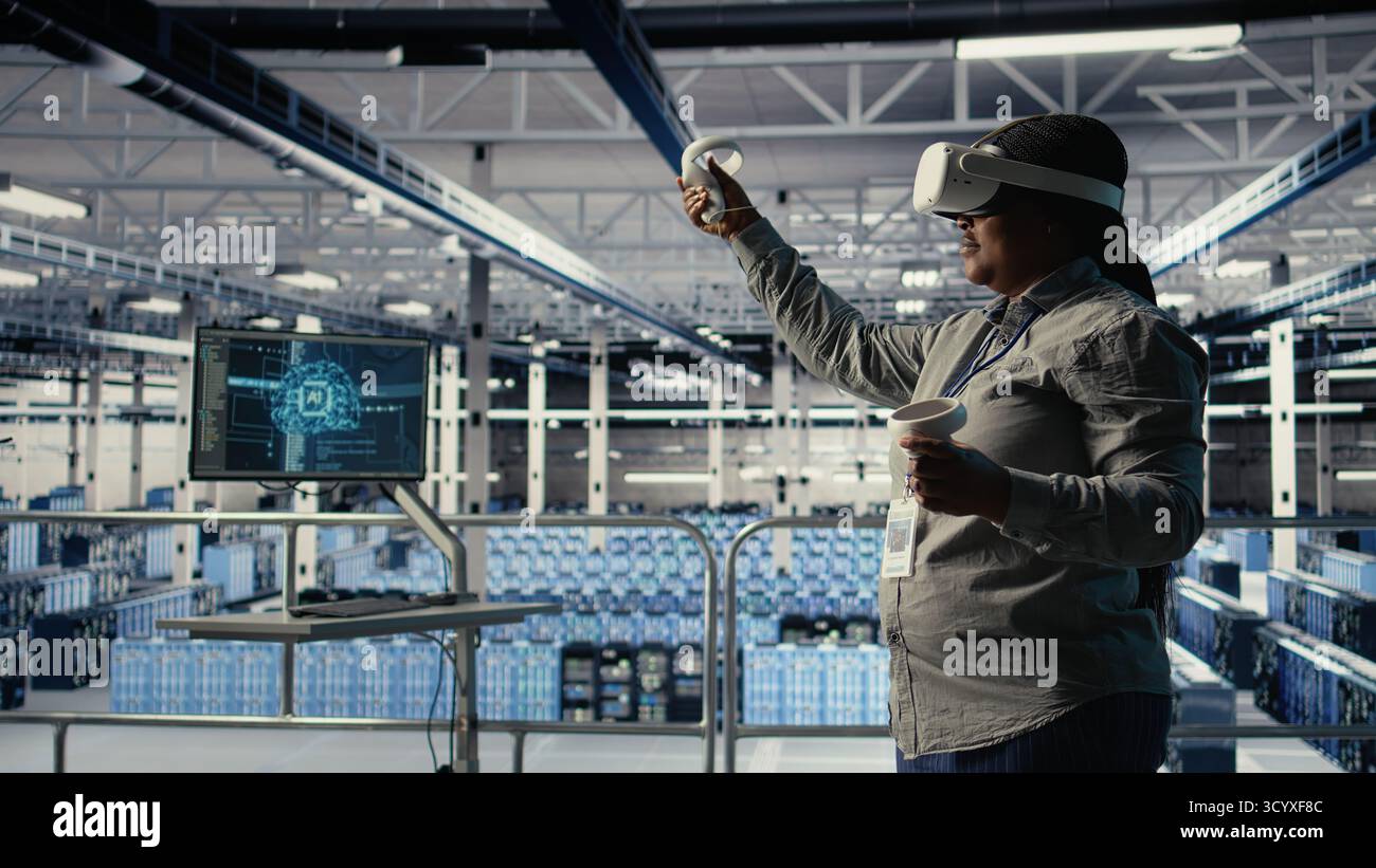 Data center technician using virtual reality, improving AI rigs processing speed. Server hub IT expert using VR headset to manage gear providing support for artificial intelligence workloads, camera A Stock Photo