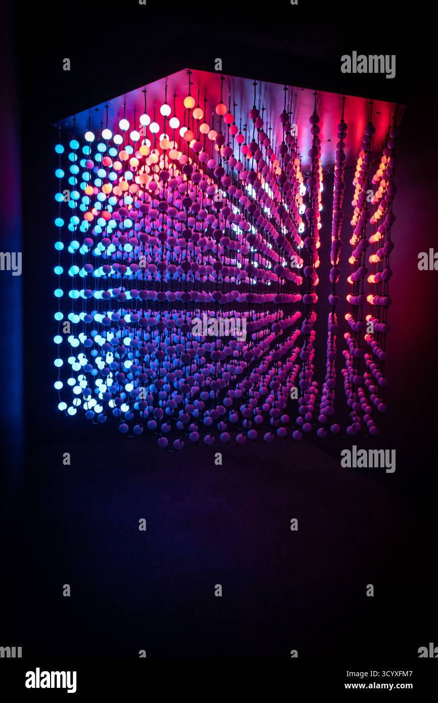A cube made of glowing, multicolored light bulbs. Stock Photo