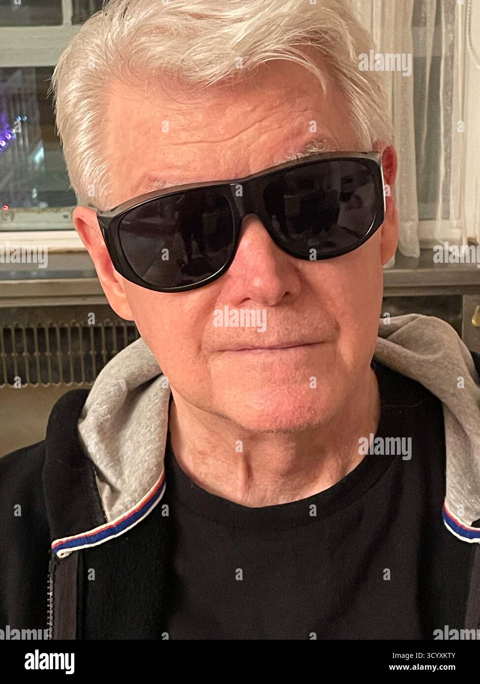 Handsome Senior recovering from eye surgery wearing wraparound protective sunglasses, 2025, New York City, United States - Smartphone Captured Stock Image