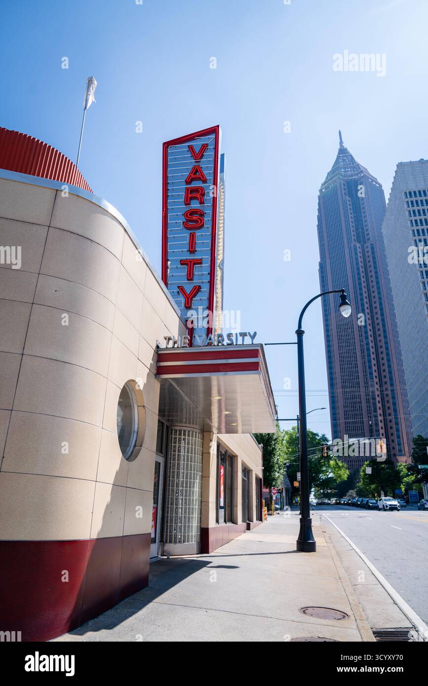 The Varsity’s iconic red neon sign glows under a clear blue sky with ...