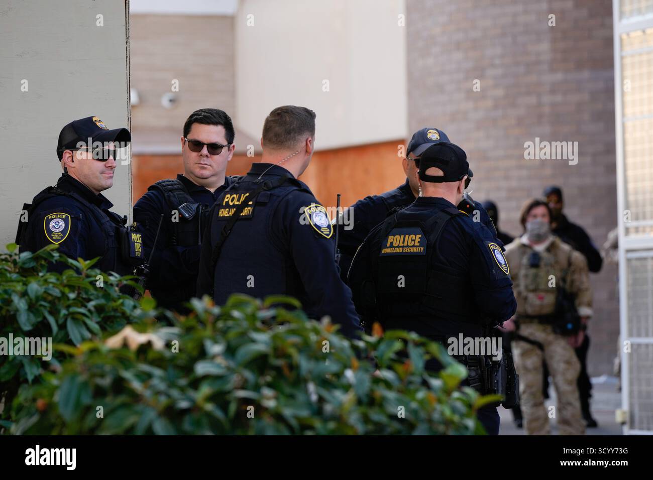 Law enforcement officers are seen outside a United States Immigration ...