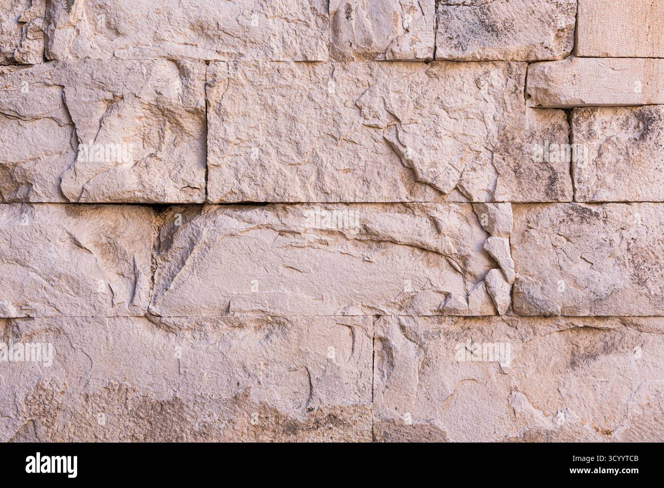 Textured stone wall creating rough surface background Stock Photo - Alamy