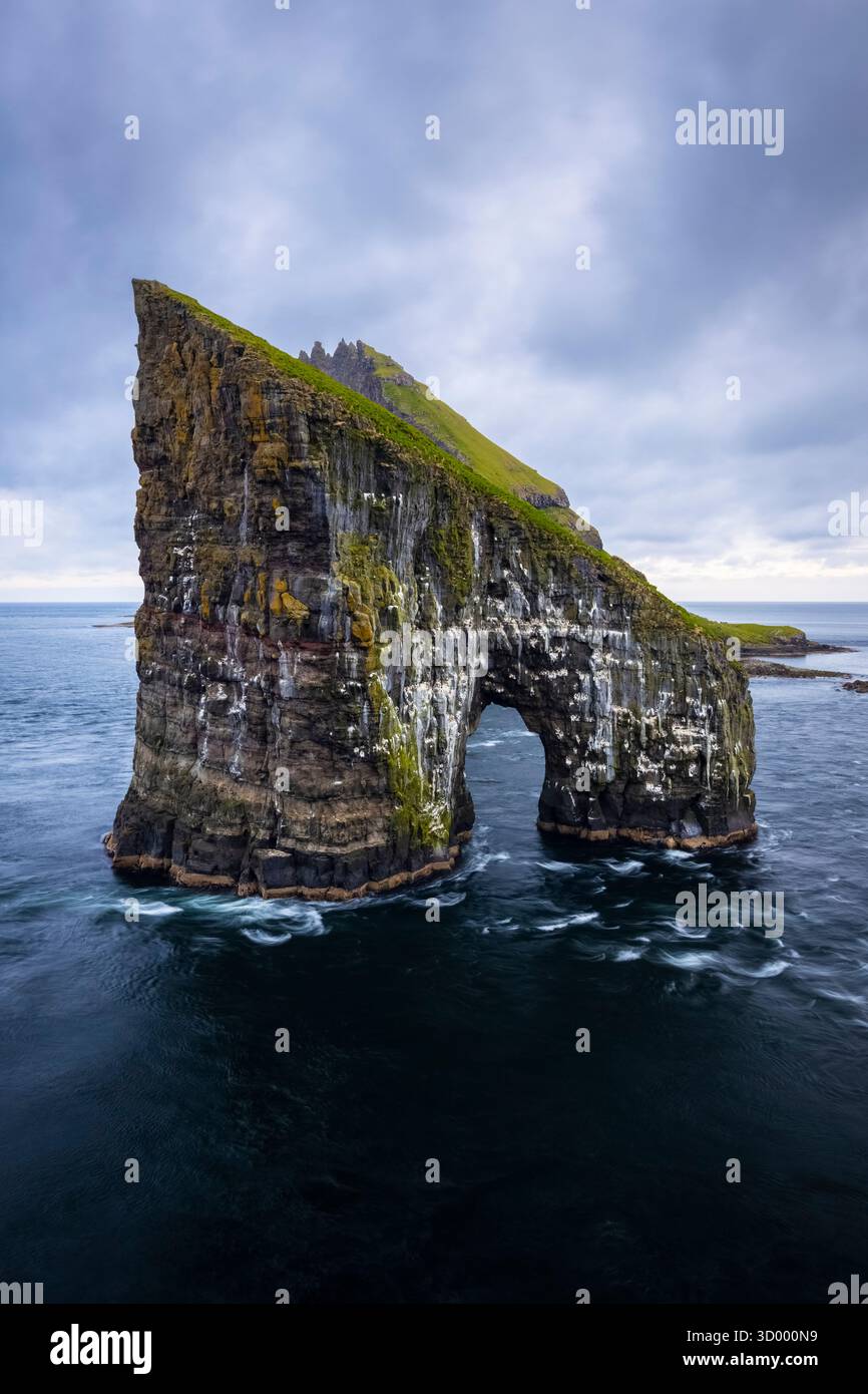 View of the trail to Drangarnir arch on a cloudy day. Vagar, Faroe Islands, Denmark, Scandinavia. Stock Photo