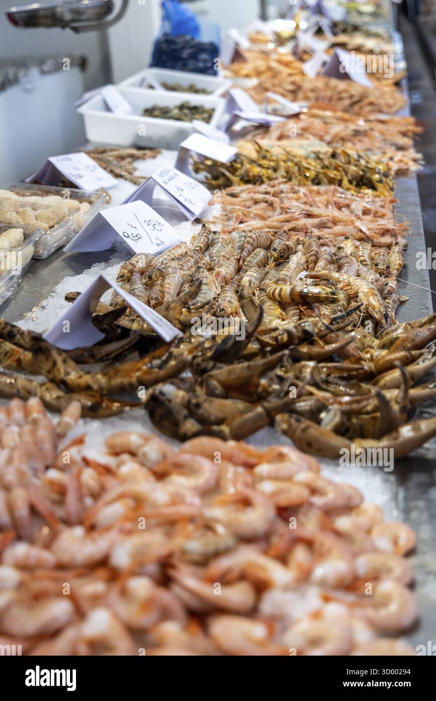 A stand selling fish at a market. Beautifully presented and shelved ...