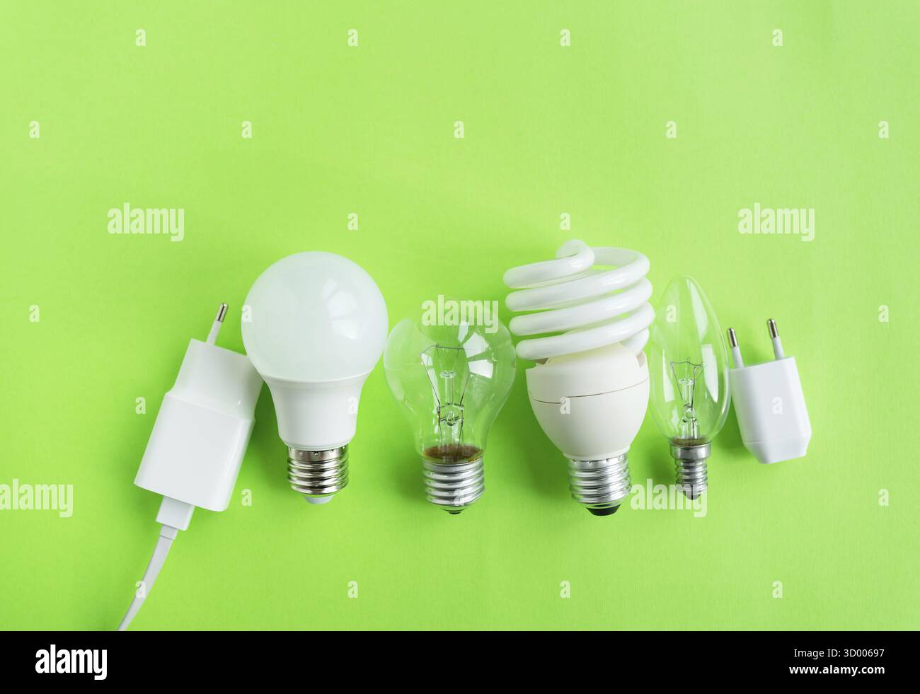 A set of different types of LED lamps isolated on a green background. Energy-saving lamps Stock Photo