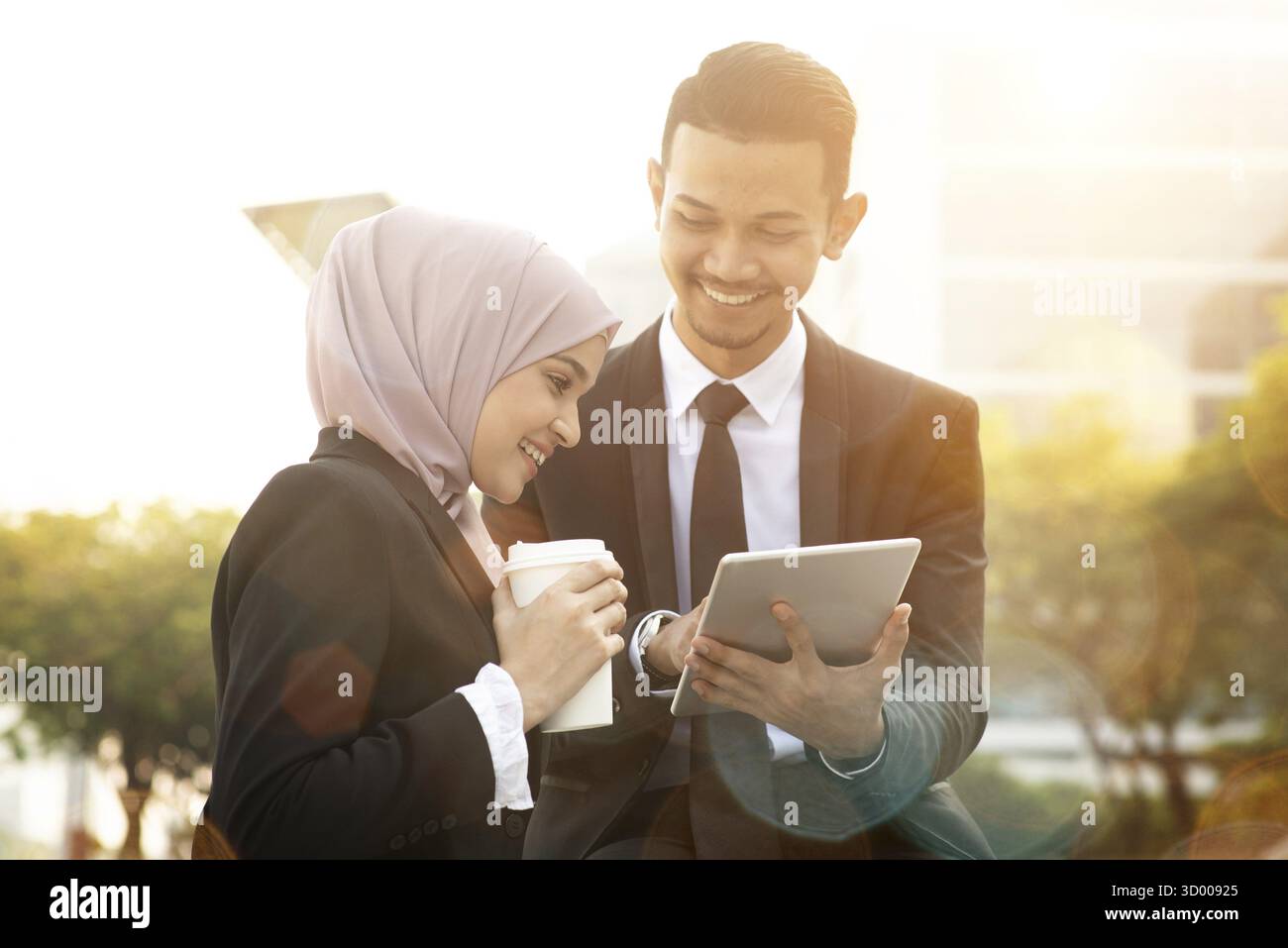 Business team discussing, using tablet pc outside office Stock Photo