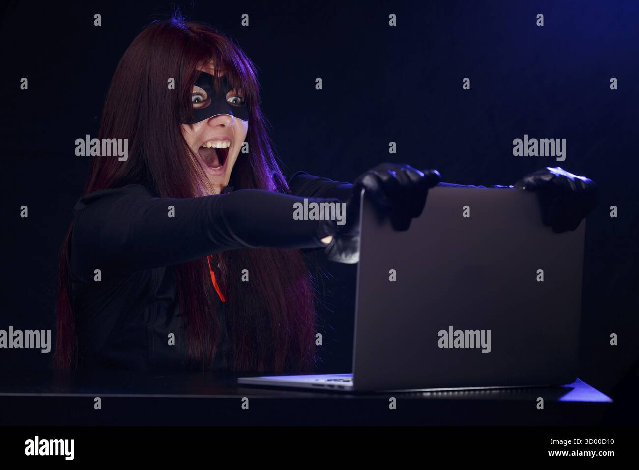 Girl steals information from computer at night Stock Photo