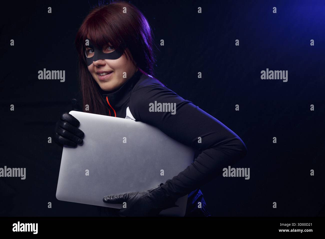 Brunette thief in black gloves steals laptop Stock Photo - Alamy