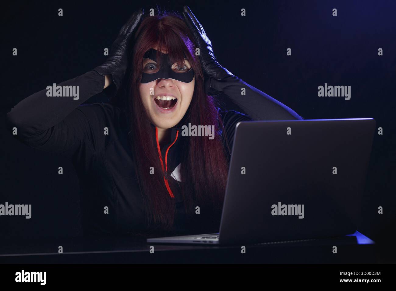 Hacker steals information from computer at night Stock Photo