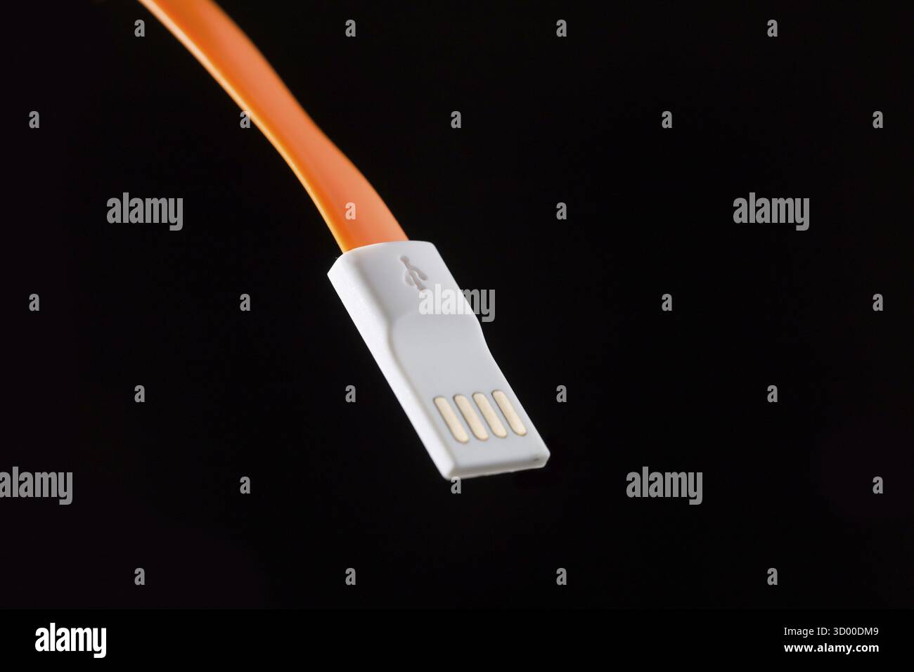 Orange cable on isolated black empty background Stock Photo