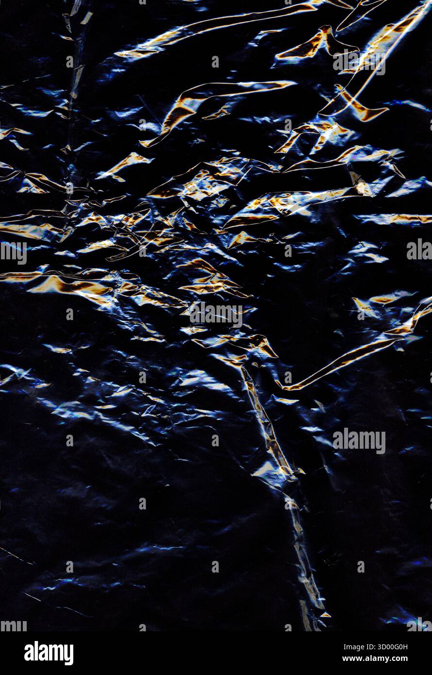 Abstract dark crumpled plastic texture with glowing light reflections creating a metallic and futuristic effect. Shiny surface and intricate folds for Stock Photo
