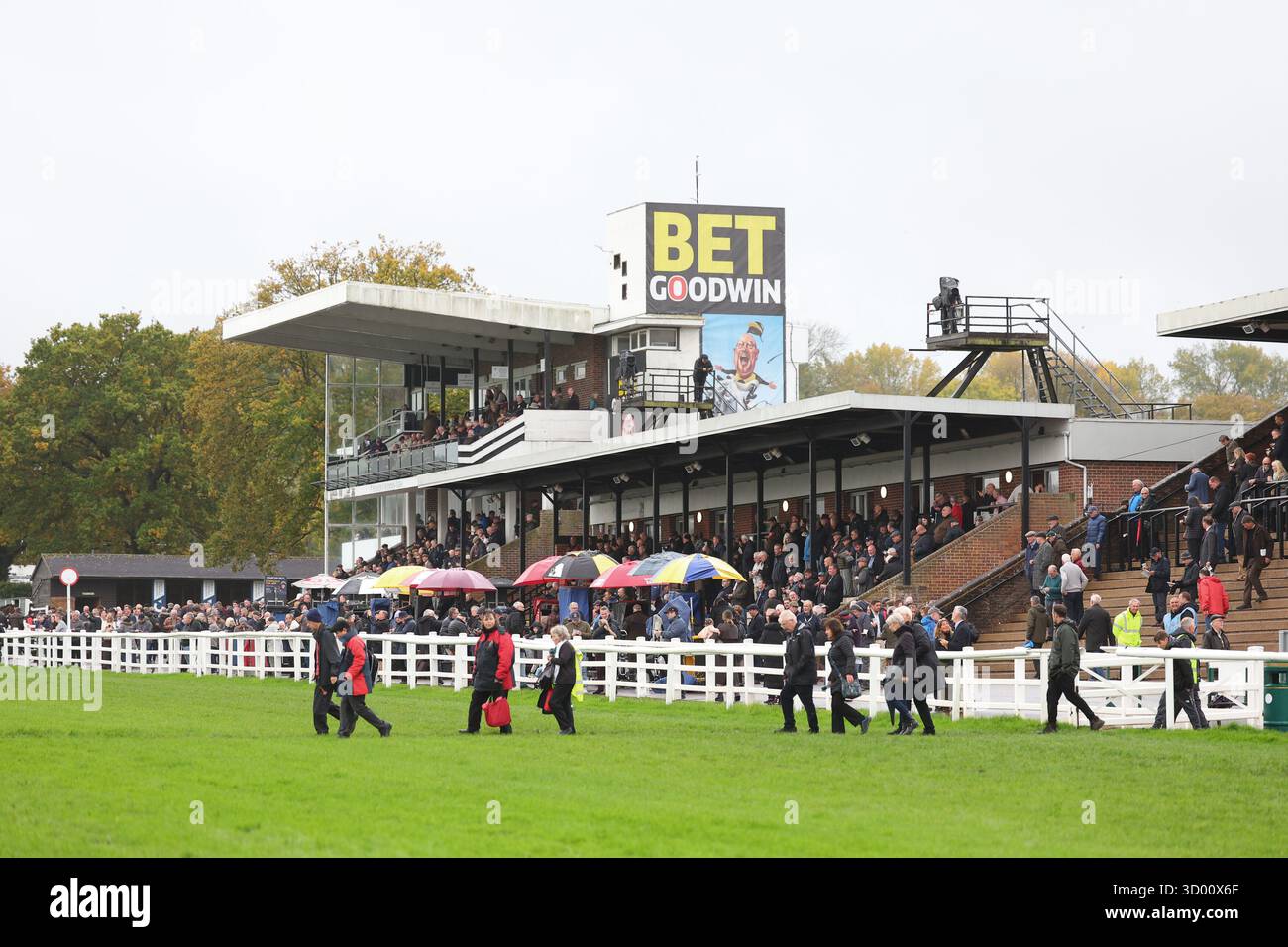 Plumpton, UK. 20th Oct, 2025. Race goers cross the track during a race meeting at Plumpton Racecourse. Credit: James Boardman/Alamy Live News Stock Photo