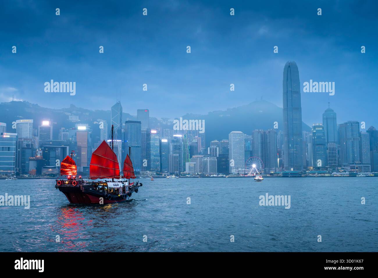 China, Hong Kong, view from Kowloon over Central District, Victoria Harbour with a junk Stock Photo