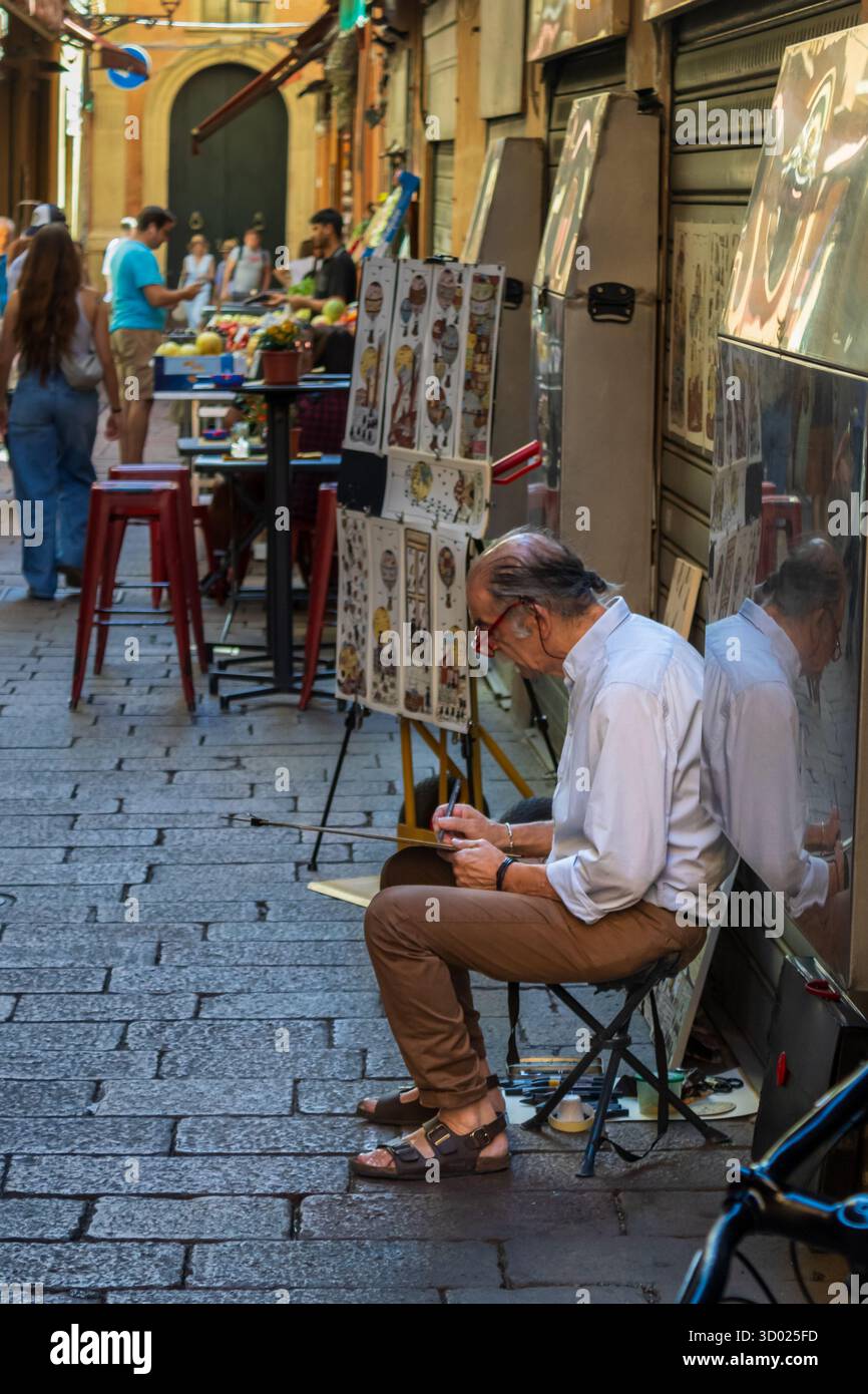 Bologna, Italy July 27-2025 Street Artist at Work in a Bologna Alleyway Stock Photo