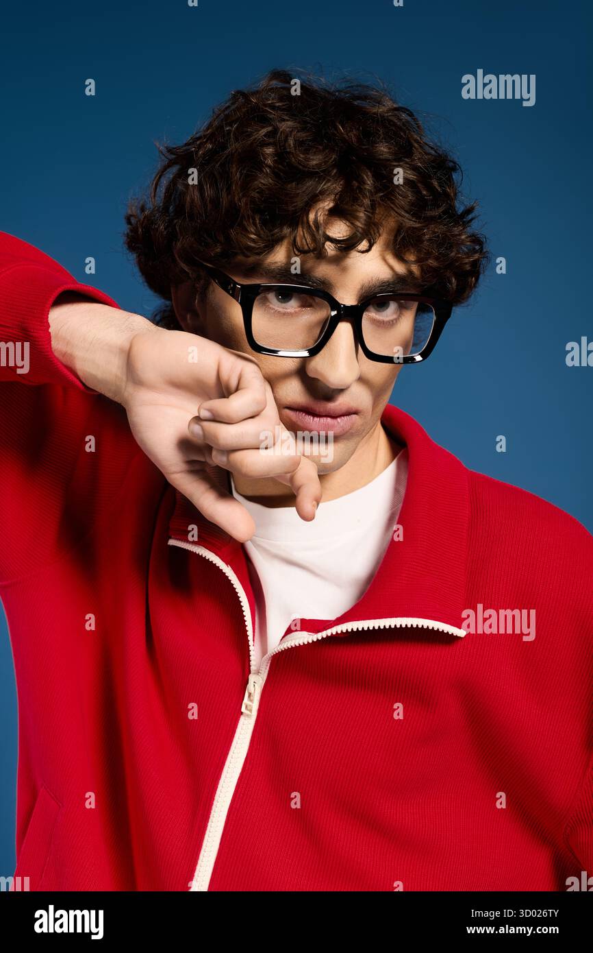 A stylish young man poses confidently in a bright red outfit and ...