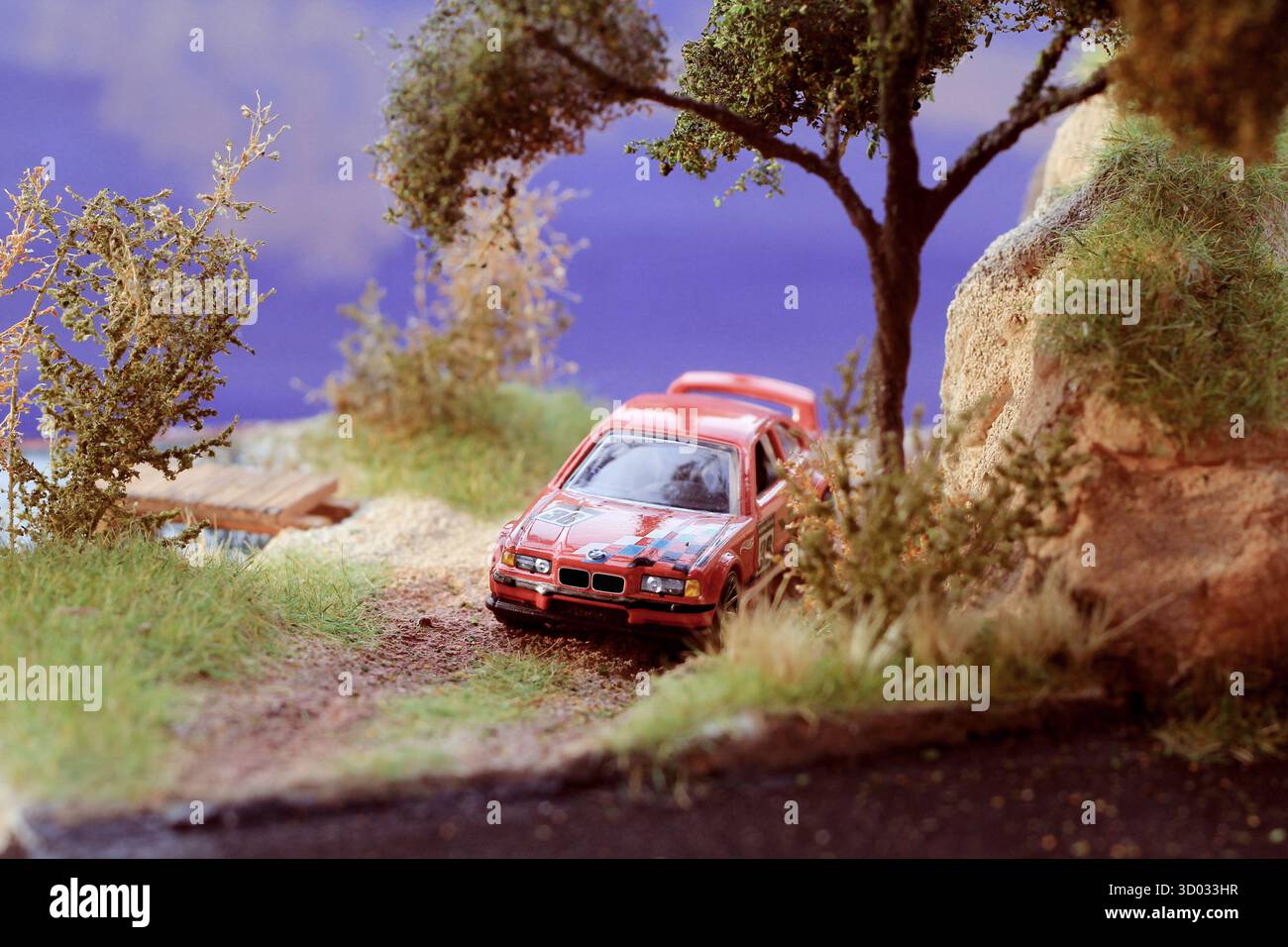Touring Rally Car Speeds Through Cliffside Trai Stock Photo